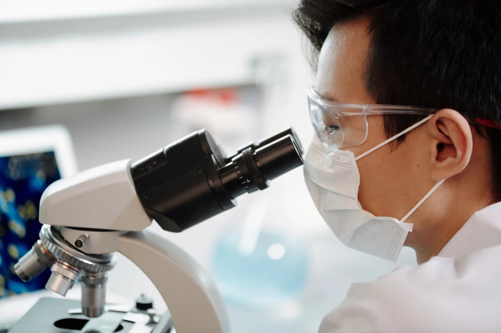 Researcher examining a sample under a microscope